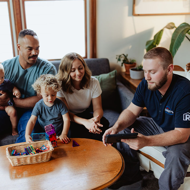 Family gathered around a table with a professional from Randy's discussing home inspection.