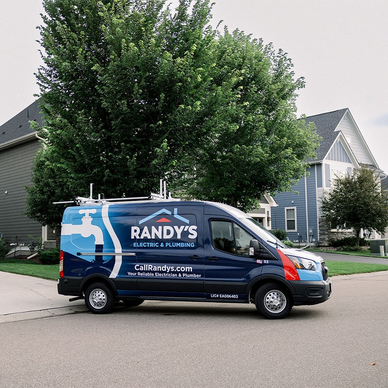 Randy's Electric & Plumbing van parked near suburban homes.