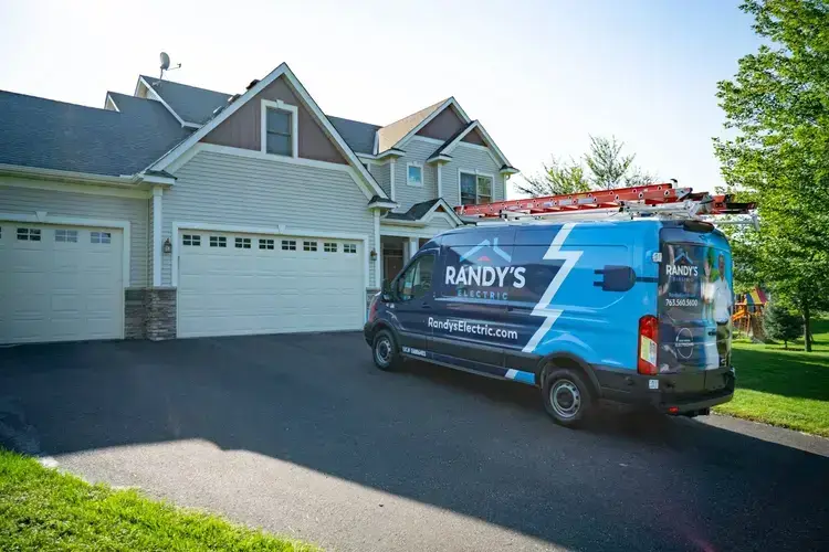 Electrician's van parked in a residential driveway with tools and branding from Randy's Electric.