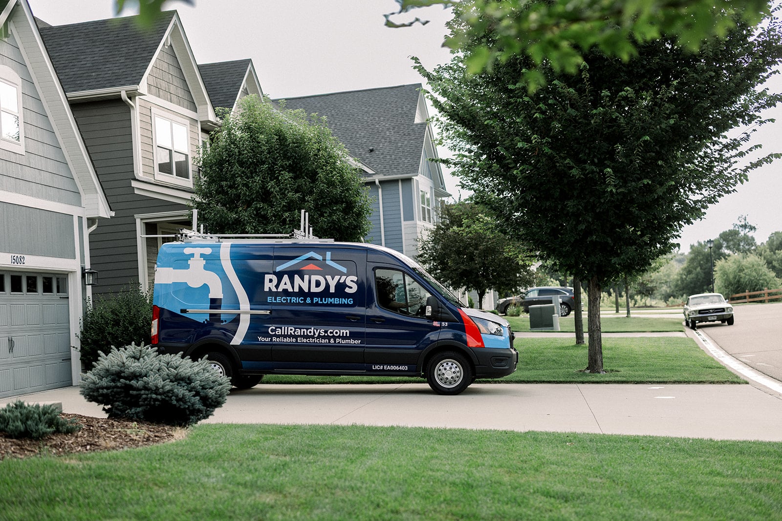 A Randy’s Electrical & Plumbing van parked outside of a suburban home.